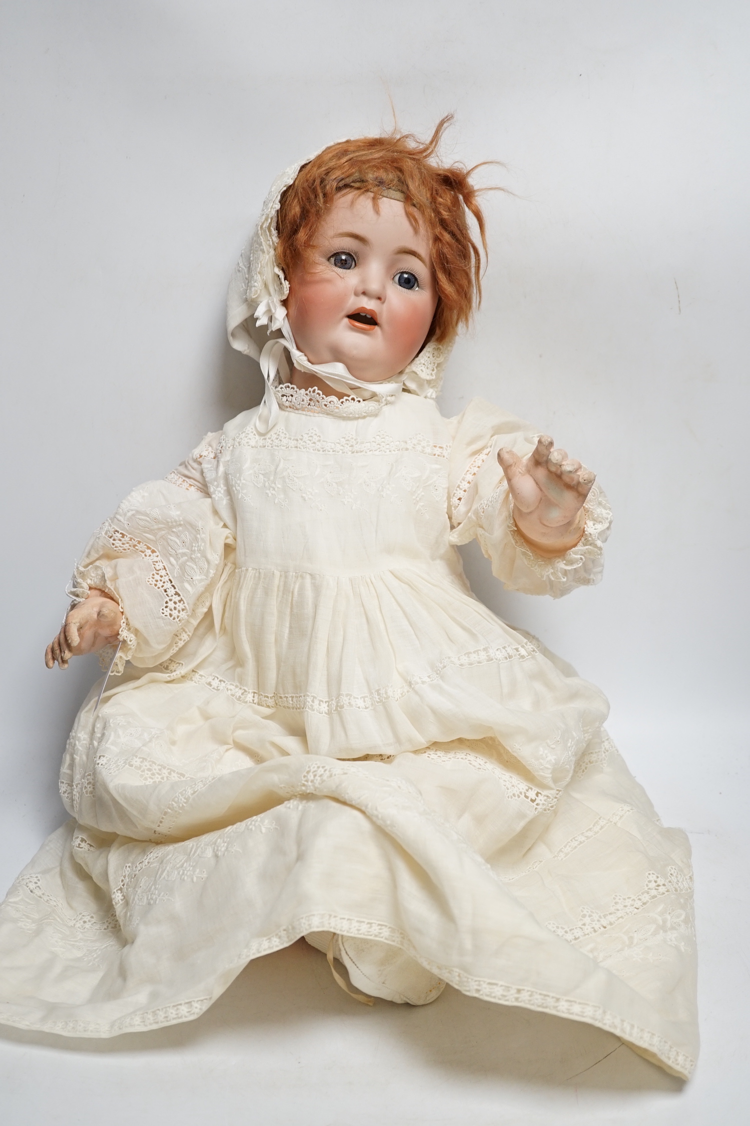 A German bent limb doll, height 63cm, hands damaged, vintage clothes, Cherie French doll's head on replaced new body, two hard plastic dolls, one Pedigree AM Dream Baby doll, soft body, small hard plastic baby in crib